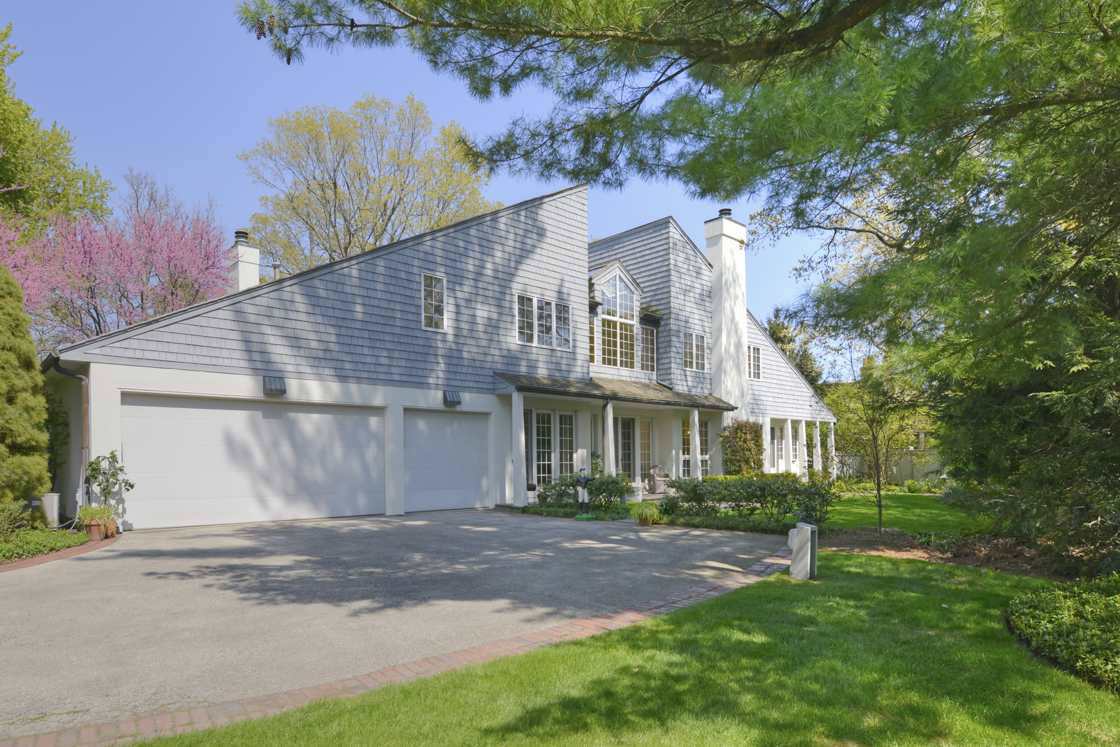 349 Sheridan Road Winnetka, IL 60093 - Photo 8 of 65 a front view of a house with a garden