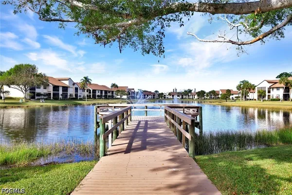 a lake view with a wooden bridge