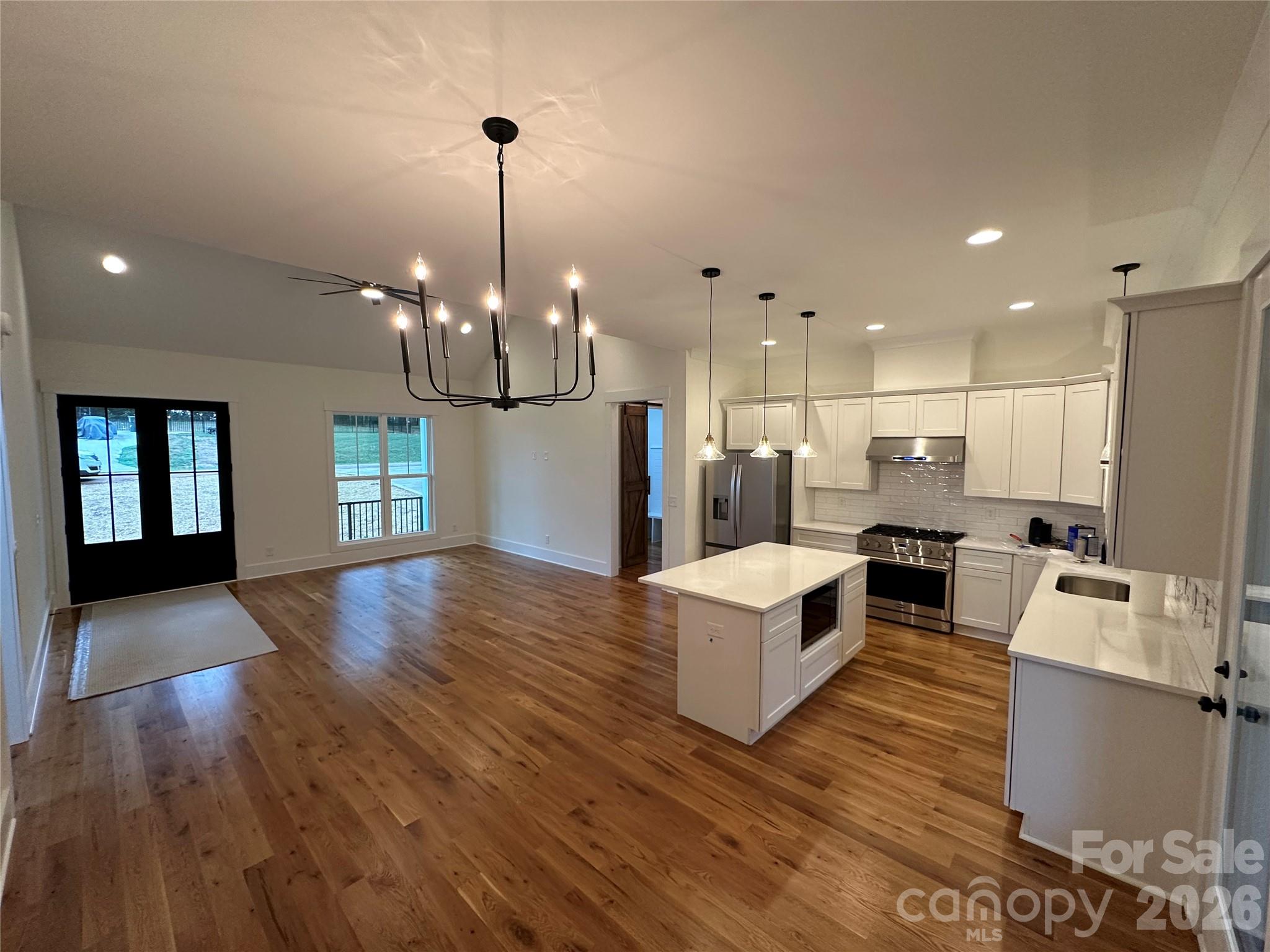 0 White Oaks Road, Unit 1 Mooresville, NC 28115 - Photo 11 of 27 a living room with kitchen island furniture and a chandelier