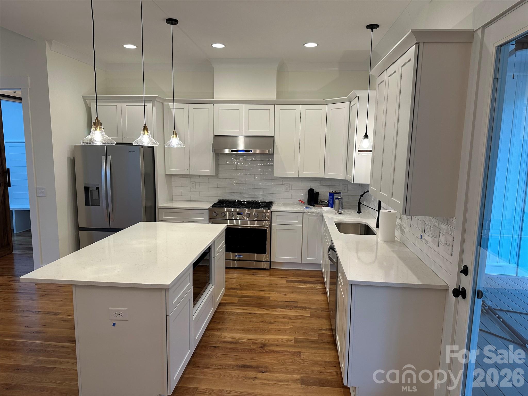 0 White Oaks Road, Unit 1 Mooresville, NC 28115 - Photo 12 of 27 a large kitchen with stainless steel appliances kitchen island a large counter top a refrigerator and a sink