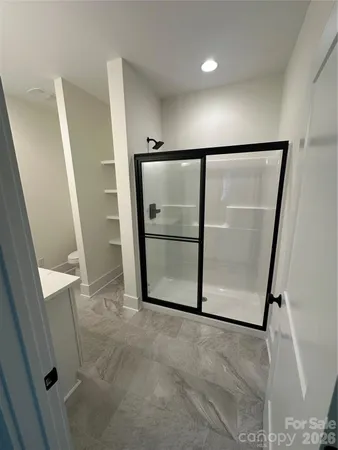 an empty room with wooden floor and a ceiling fan
