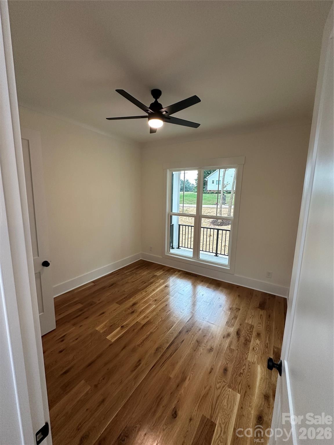 0 White Oaks Road, Unit 1 Mooresville, NC 28115 - Photo 23 of 27 a view of an empty room with wooden floor and a window
