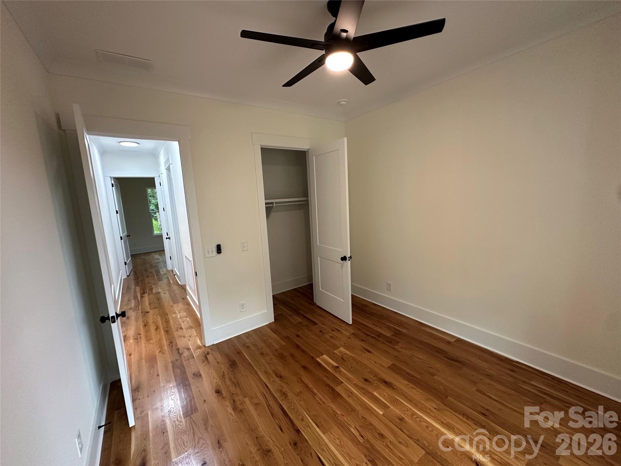 0 White Oaks Road, Unit 1 Mooresville, NC 28115 - Photo 24 of 27 an empty room with wooden floor and a ceiling fan