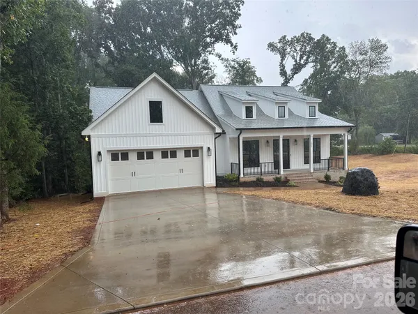 a large kitchen with stainless steel appliances kitchen island a large counter top a refrigerator and a sink