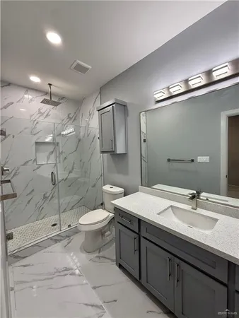 a bathroom with a sink toilet and shower