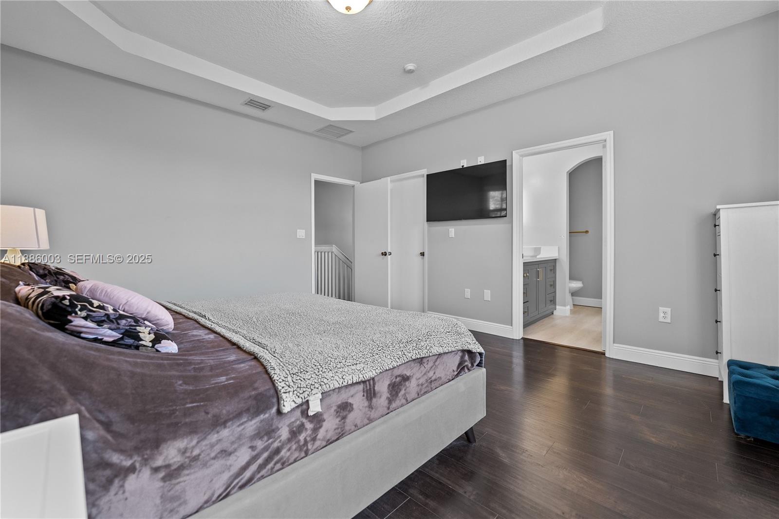3070 Southwest 153rd Path Miami, FL 33185 - Photo 36 of 41 a bedroom with a bed and a flat screen tv