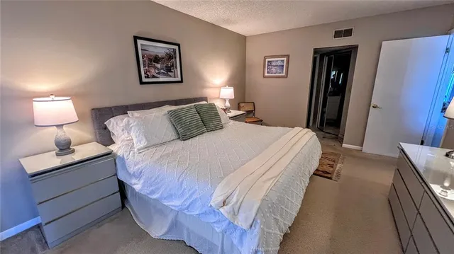 a bedroom with a bed and a lamp