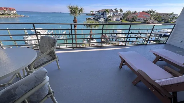 a view of a chairs and table in the balcony