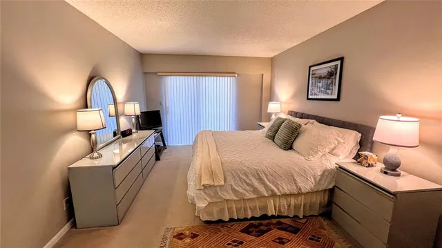a bedroom with a bed and a dresser with mirror
