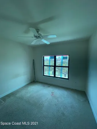 an empty room with a empty space and windows