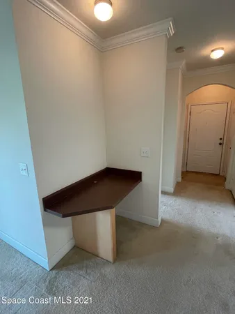 a living room with furniture and large windows