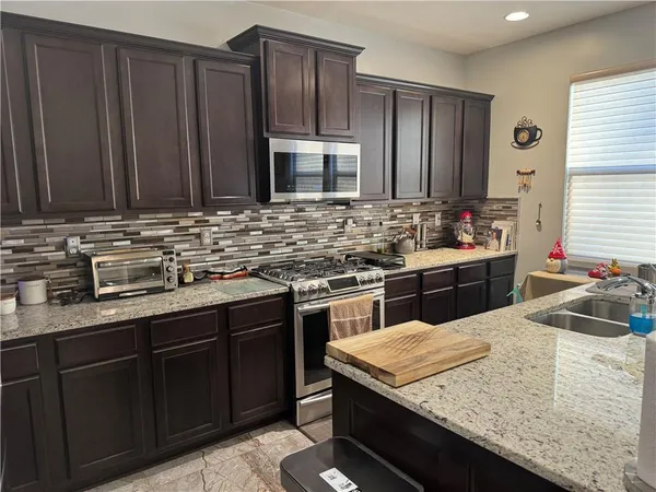 a close view of a stove top oven and sitting space