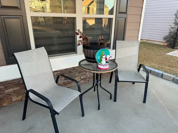 a view of a chairs and table in the balcony