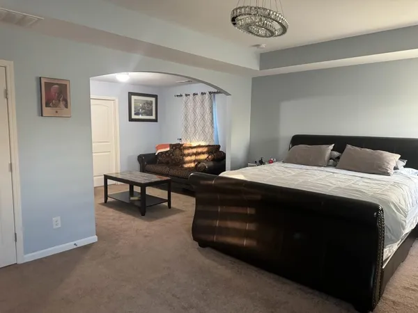 a bed sitting in a bedroom next to a window