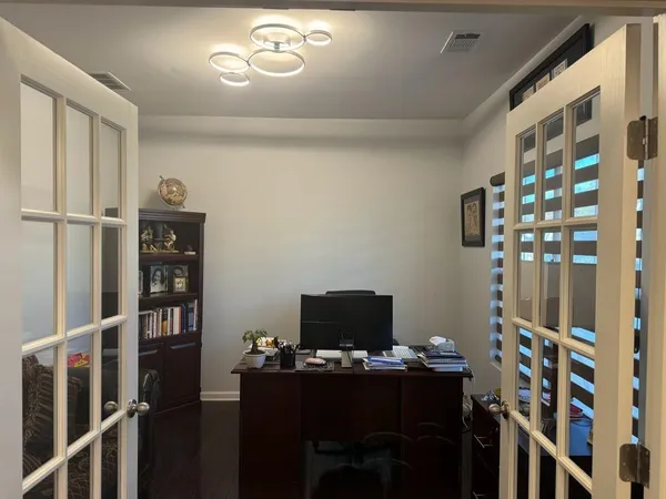 a view of a workspace with furniture and wooden floor