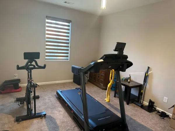 a kitchen with granite countertop stainless steel appliances a stove a sink a microwave a refrigerator and a cabinets