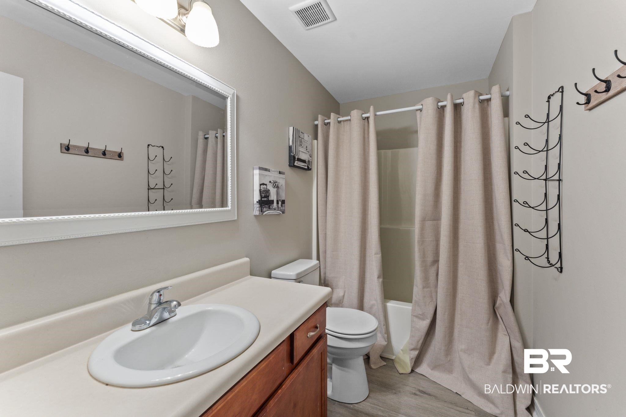 1549 Majesty Loop Foley, AL 36535 - Photo 19 of 25 Full bathroom featuring shower / bath combination with curtain, light wood-type flooring, and vanity