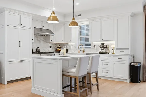 a kitchen with cabinets stainless steel appliances and a window