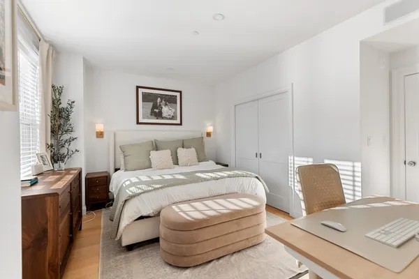 a bedroom with a bed and chair