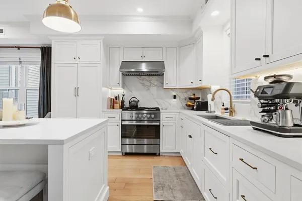 a kitchen with cabinets appliances and a window