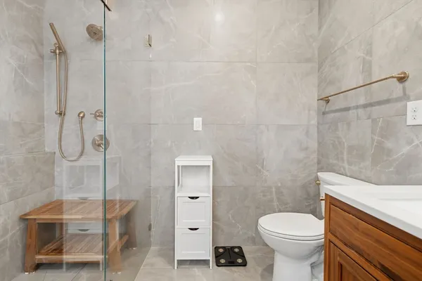 a bathroom with a toilet a sink and shower
