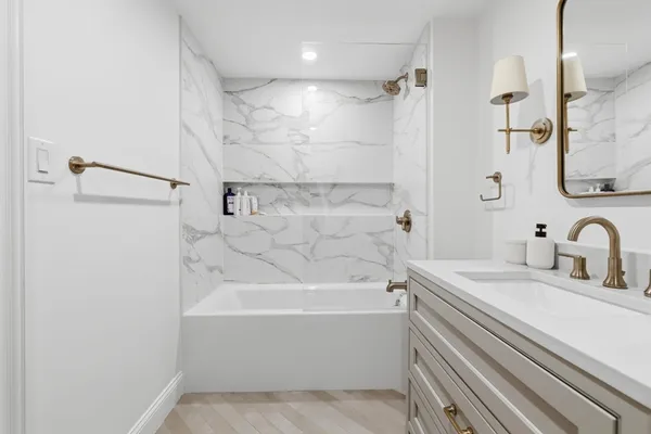 a bathroom with a sink a mirror and a bathtub