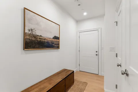 a hallway with sliding door and couch