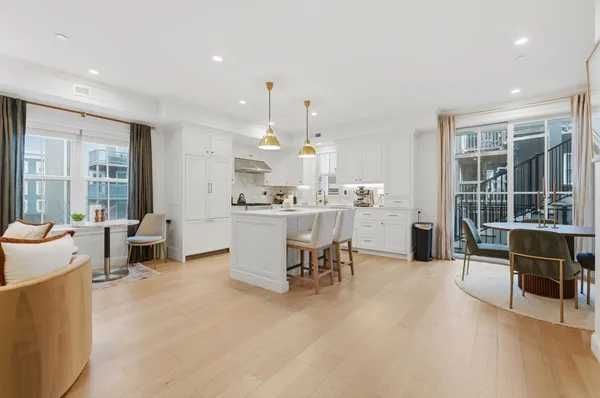 a living room with furniture and kitchen view