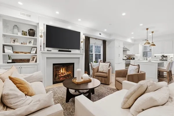 a living room with furniture fireplace and flat screen tv