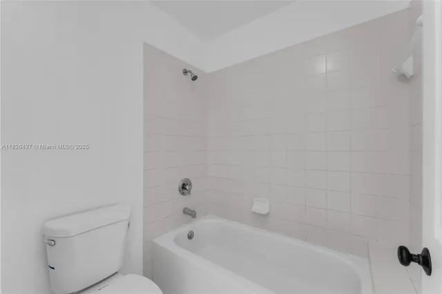 a bathroom with a bathtub and toilet