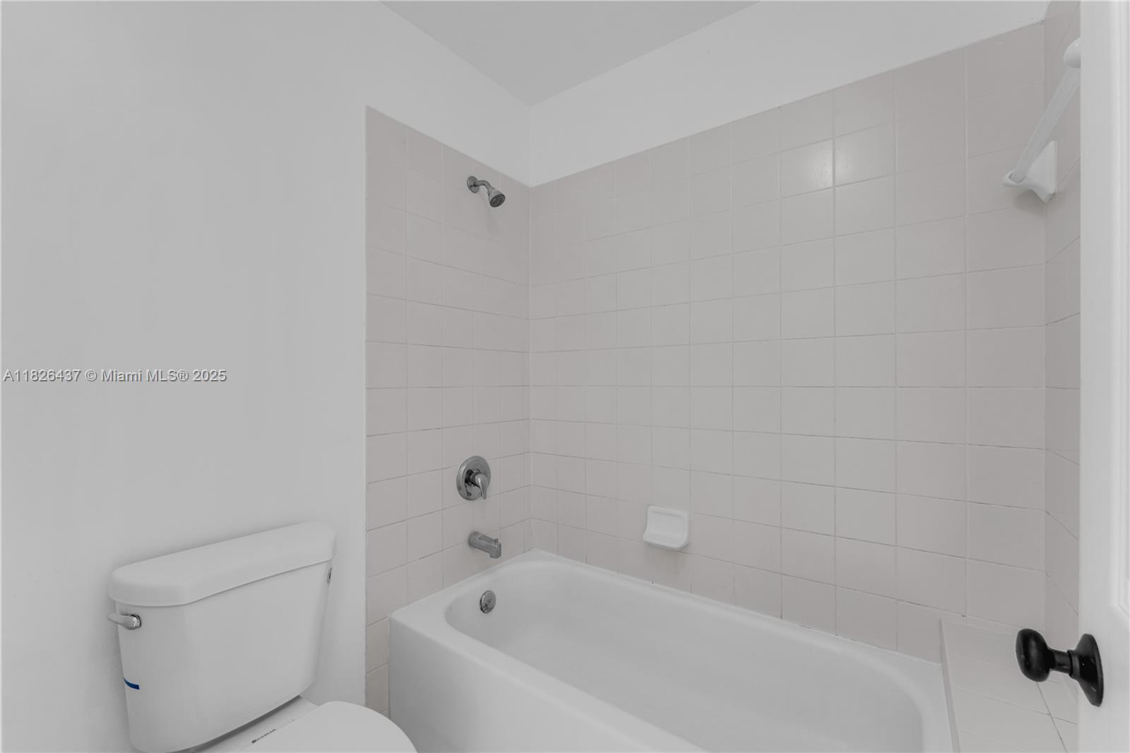 22921 Southwest 88th Place, Unit 301 Cutler Bay, FL 33190 - Photo 16 of 24 a bathroom with a bathtub and toilet