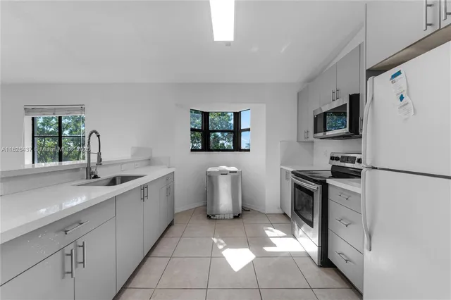 a kitchen with a sink stove and refrigerator