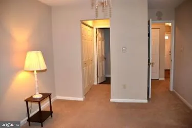 a view of empty room with a window and a mirror