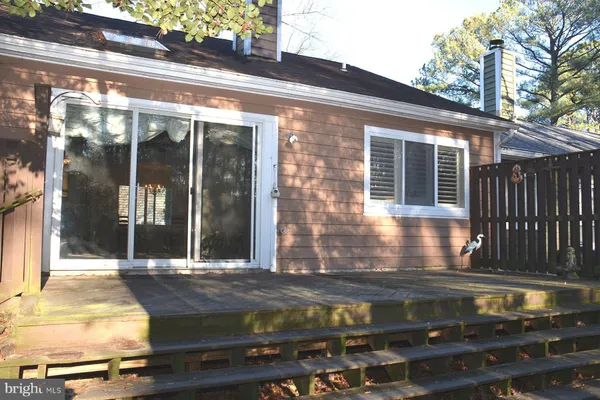 a view of brick house with potted plants