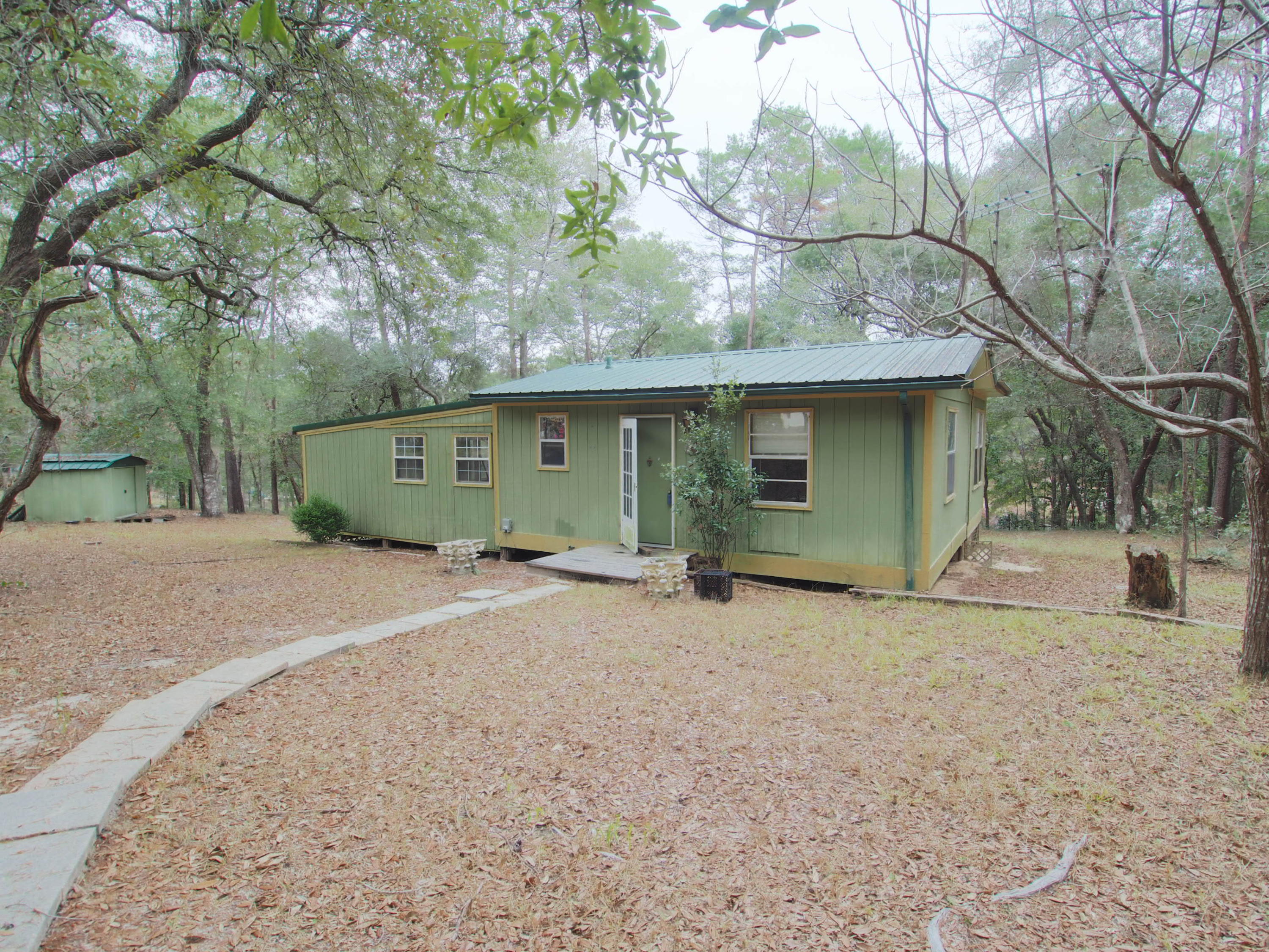 240 Roberts Road East DeFuniak Springs, FL 32433 - Photo 2 of 26 a view of a house with a yard and garage