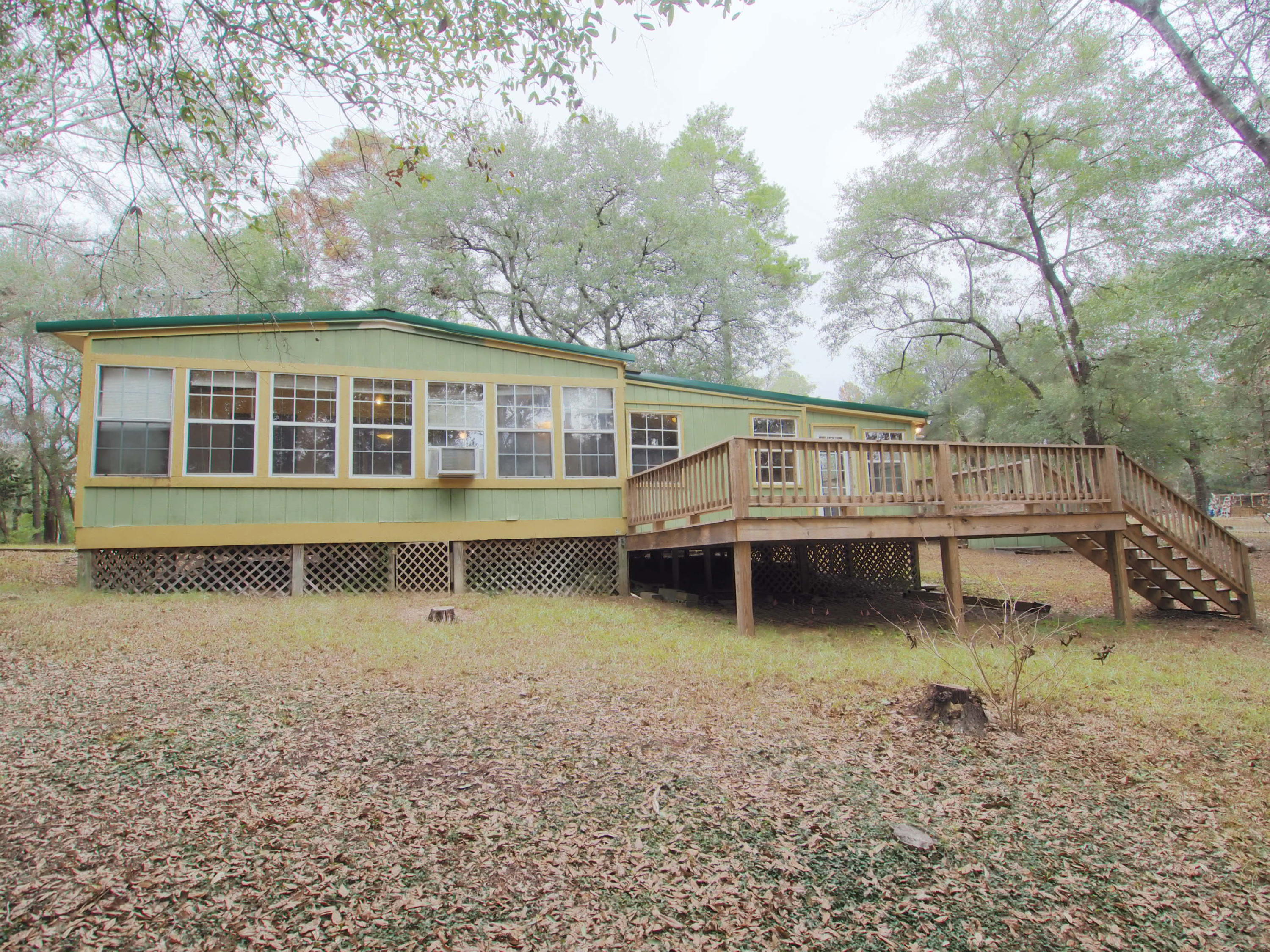 240 Roberts Road East DeFuniak Springs, FL 32433 - Photo 13 of 26 a view of a house with yard and sitting area