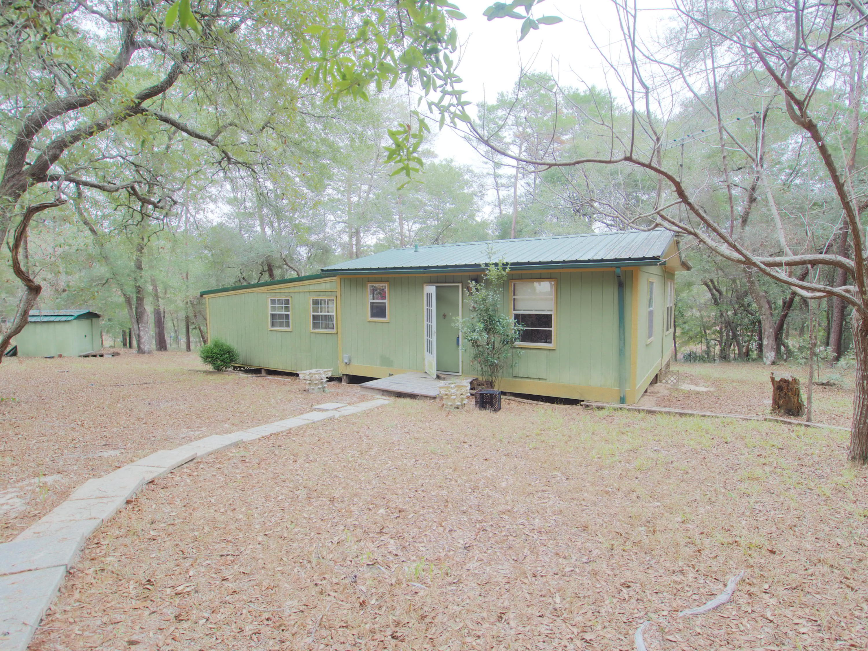 240 Roberts Road East DeFuniak Springs, FL 32433 - Photo 17 of 26 a view of a house with a outdoor space and a tree