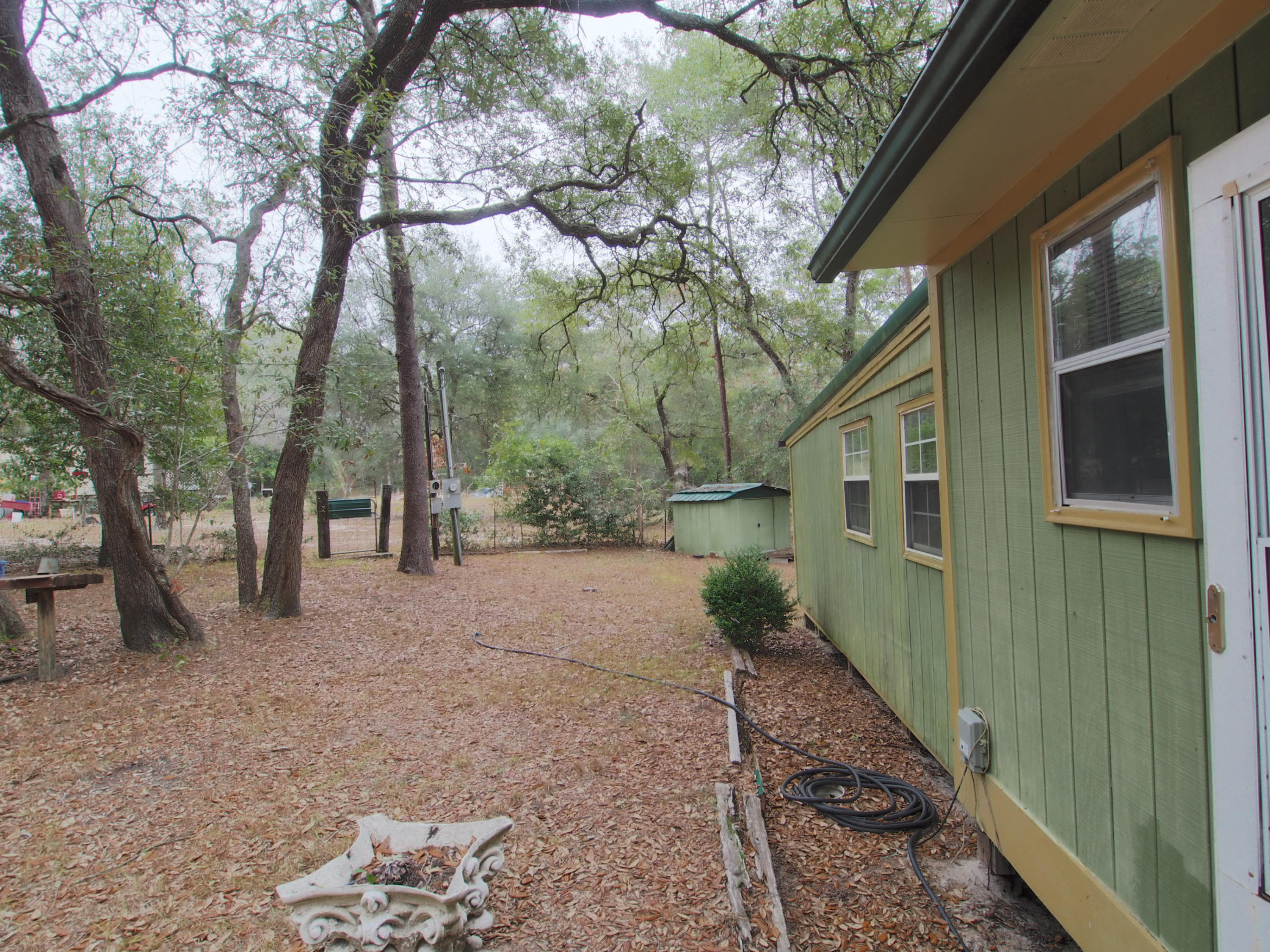 240 Roberts Road East DeFuniak Springs, FL 32433 - Photo 19 of 26 a view of a backyard with large trees