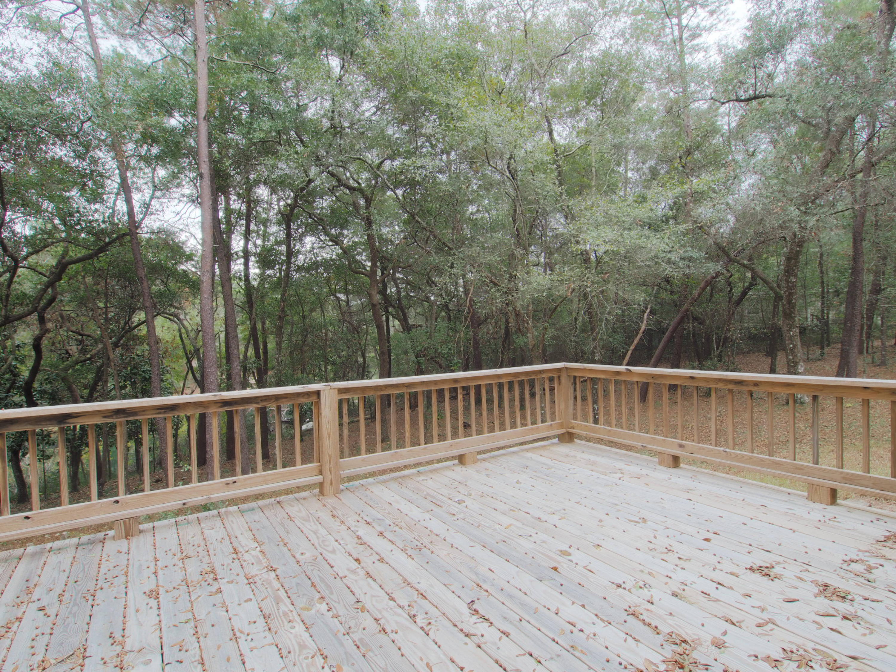 240 Roberts Road East DeFuniak Springs, FL 32433 - Photo 22 of 26 a balcony with wooden floor and trees