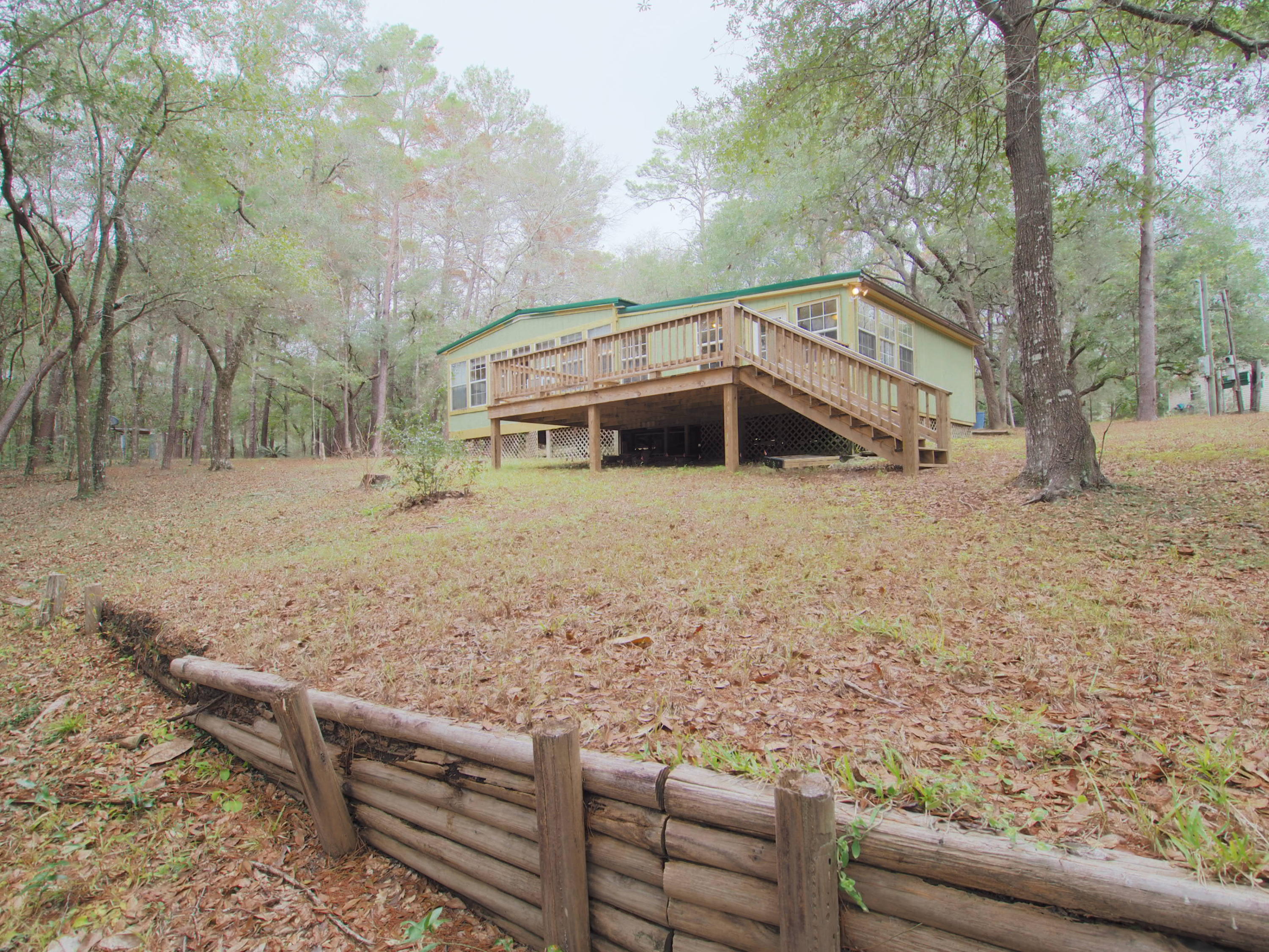 240 Roberts Road East DeFuniak Springs, FL 32433 - Photo 26 of 26 a view of a yard with large trees