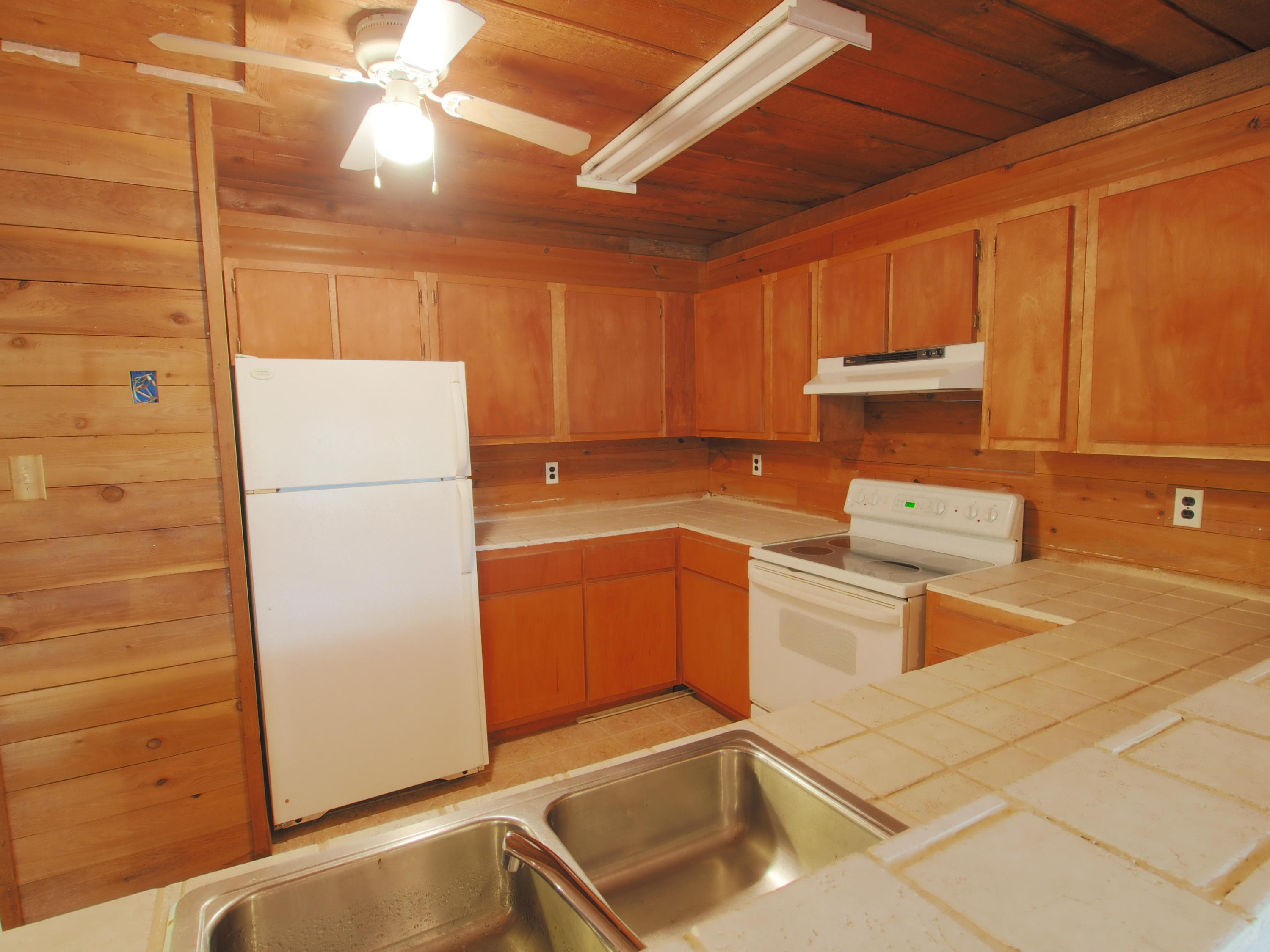 240 Roberts Road East DeFuniak Springs, FL 32433 - Photo 4 of 26 a kitchen with a refrigerator and a stove top oven