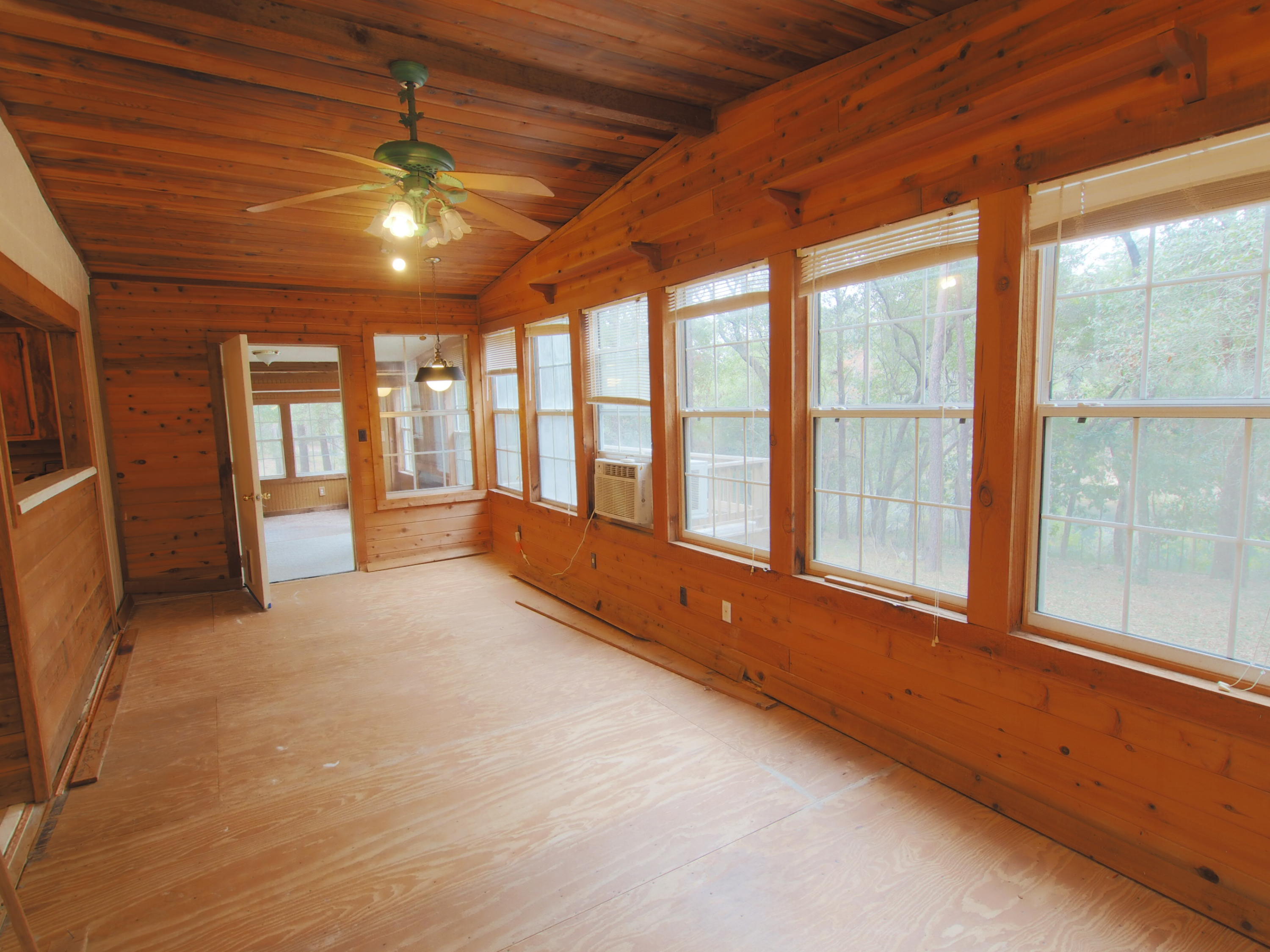 240 Roberts Road East DeFuniak Springs, FL 32433 - Photo 5 of 26 a view of an empty room with a fireplace and a large window