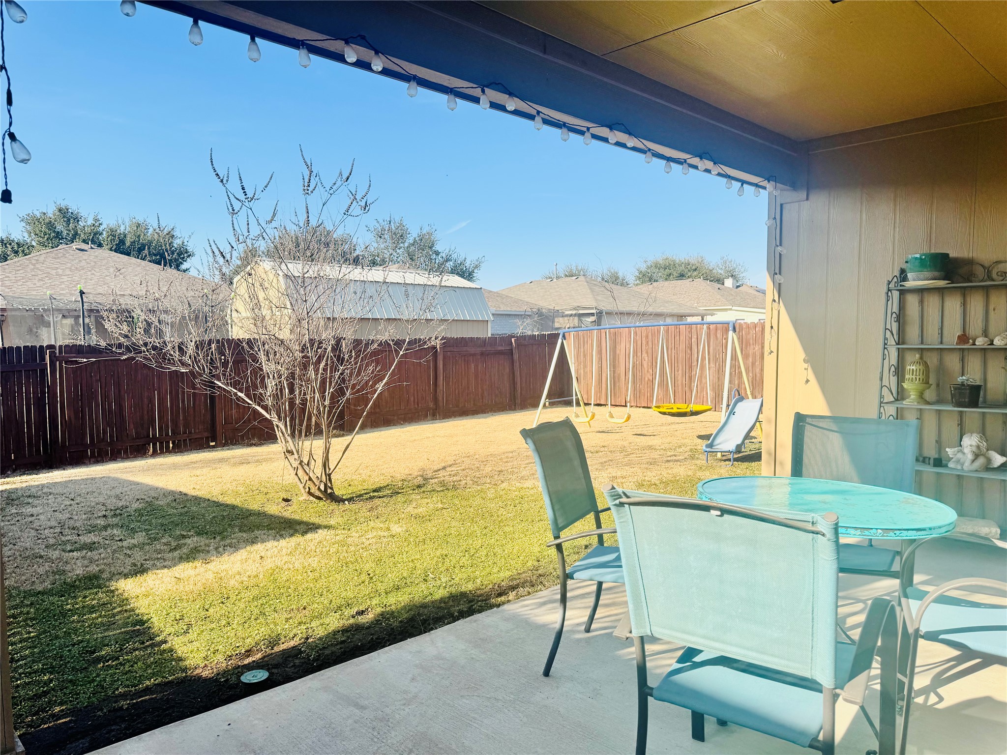 413 Gettysburg Loop Elgin, TX 78621 - Photo 32 of 32 Fenced backyard featuring outdoor dining area and a patio area