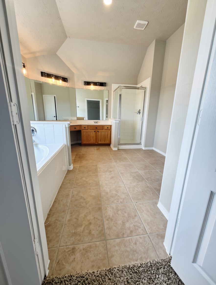 3002 Mayday Run Court Spring, TX 77373 - Photo 15 of 31 Spacious primary bathroom featuring a relaxing soaking tub and separate walk-in shower, offering a comfortable and functional retreat for everyday living.