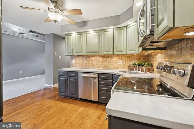 a kitchen with stainless steel appliances granite countertop a sink and a stove