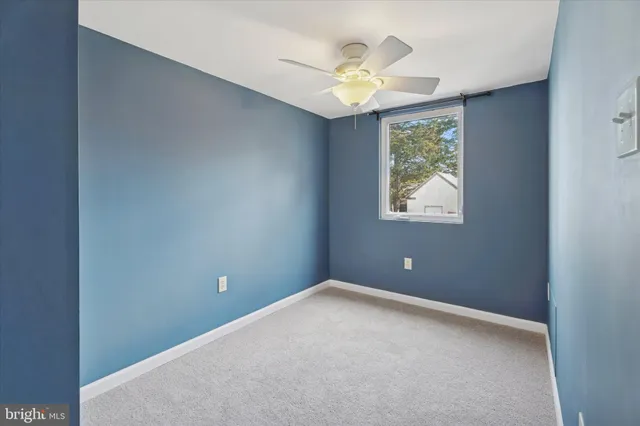 an empty room with window and wooden floor