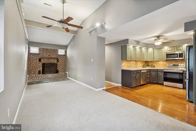 a large kitchen with a sink stainless steel appliances and cabinets
