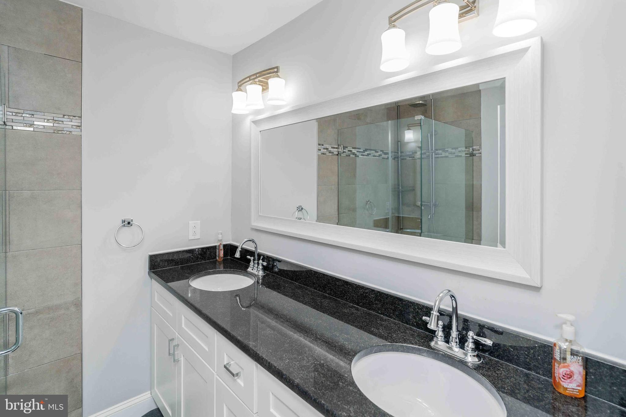 137 Idlewild Road Levittown, PA 19057 - Photo 15 of 34 a bathroom with a granite countertop sink and a mirror