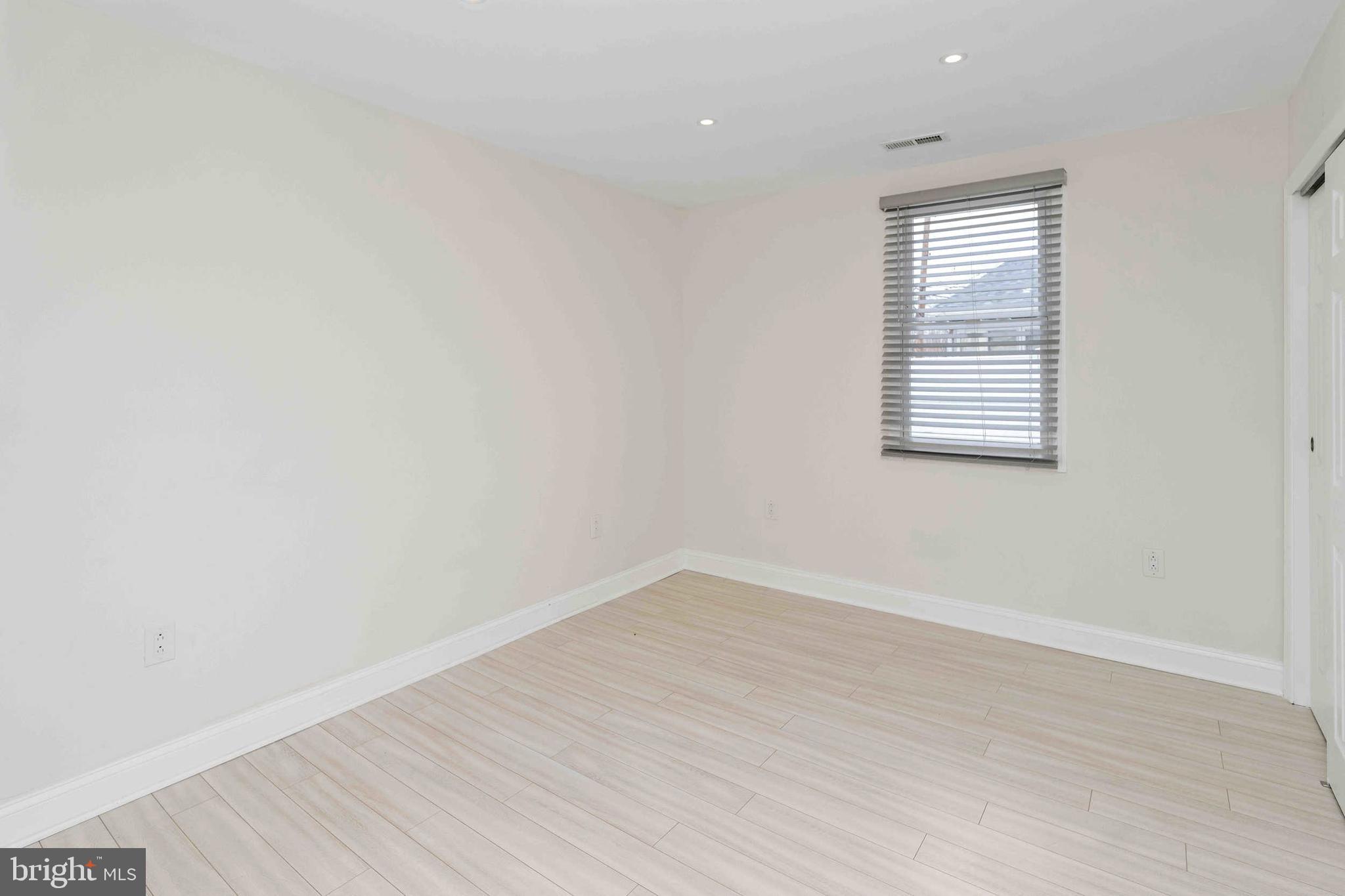 137 Idlewild Road Levittown, PA 19057 - Photo 18 of 34 an empty room with wooden floor and windows