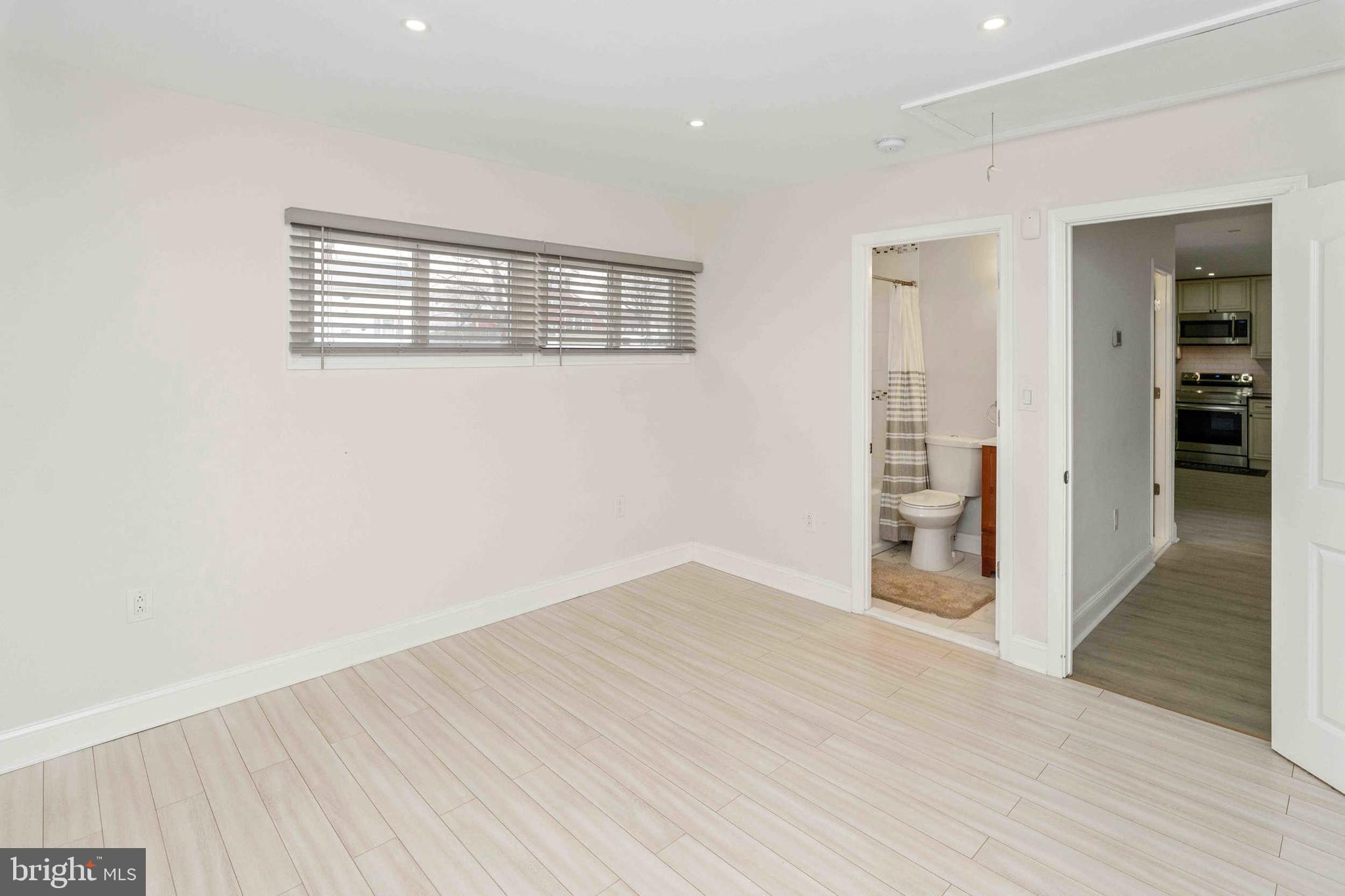 137 Idlewild Road Levittown, PA 19057 - Photo 20 of 34 a view of an empty room with wooden floor and a window